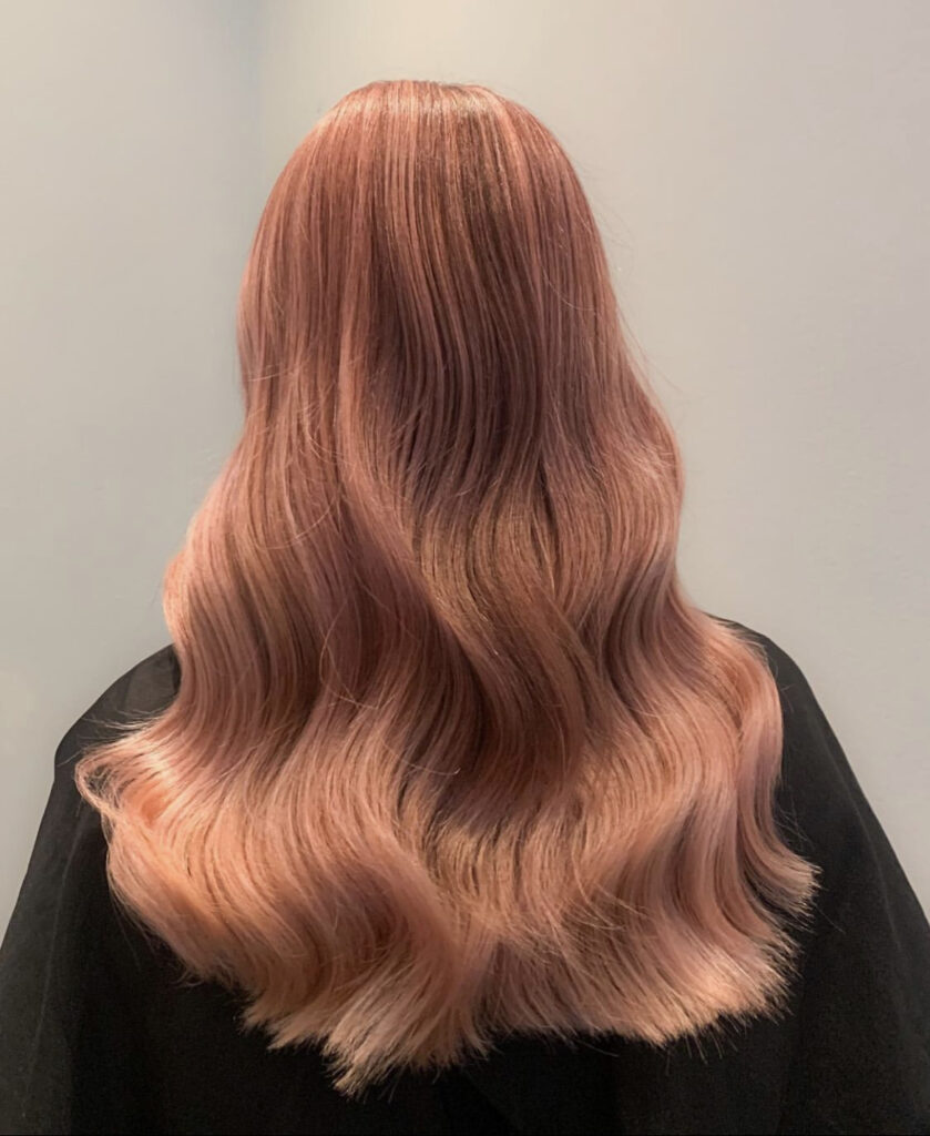 back of woman with long peach coloured hair