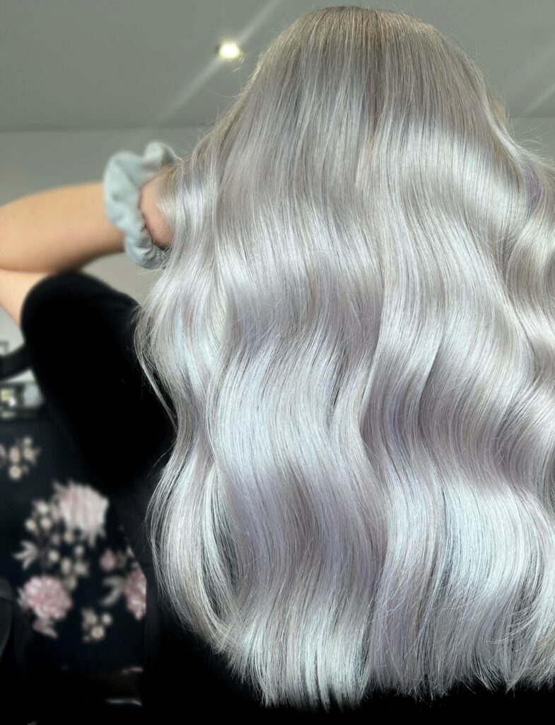 back of womans head woman has long silver lightly waved hair