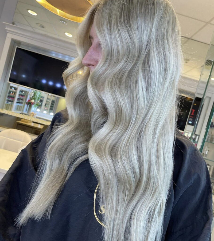 woman with long silver blonde hair in salon