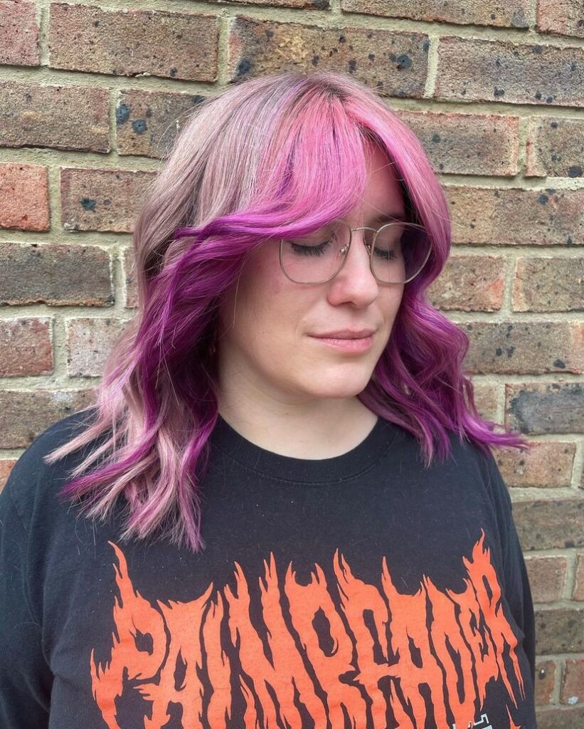 woman wearing glasses with long pink and silver hair