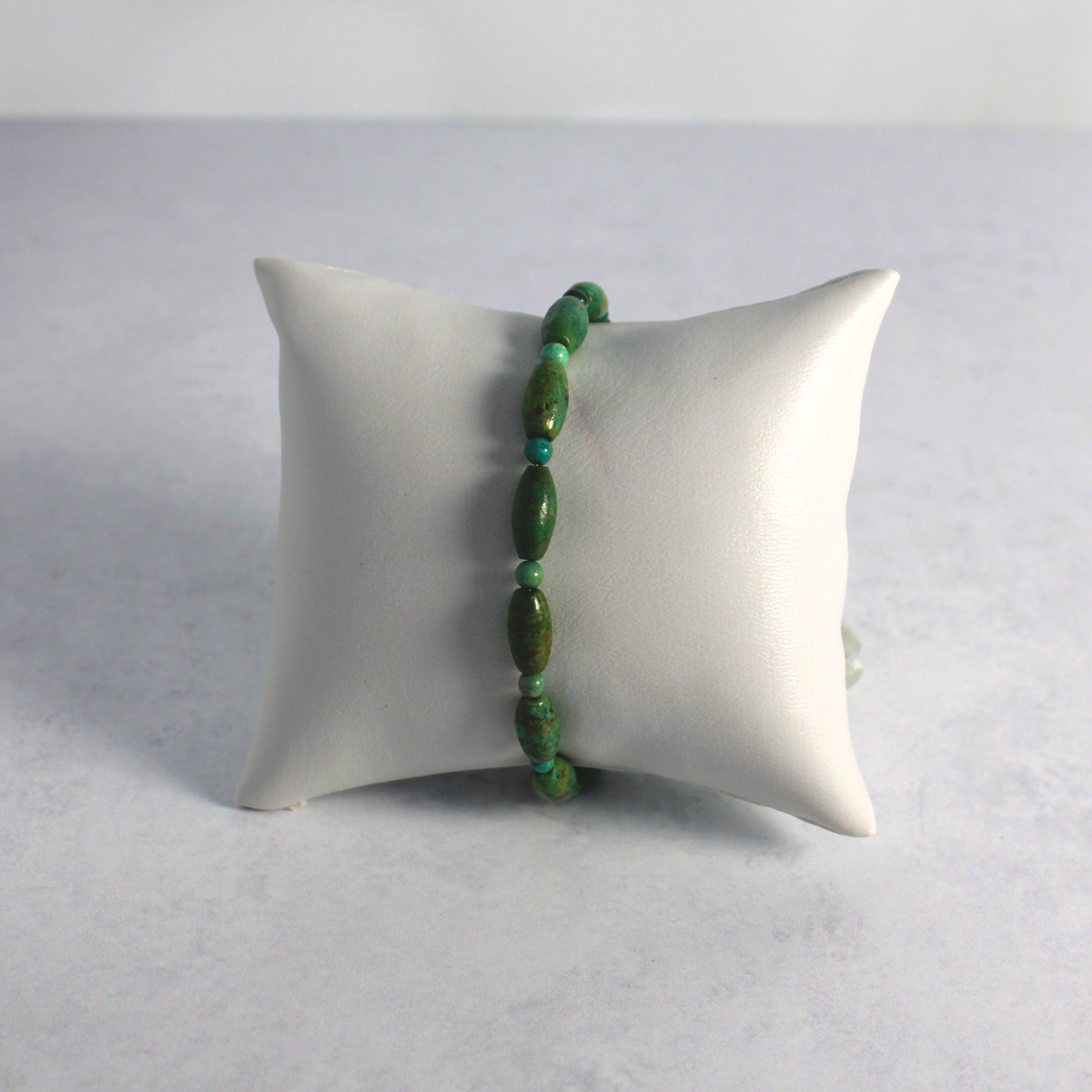 Turquoise bracelet on a pillow