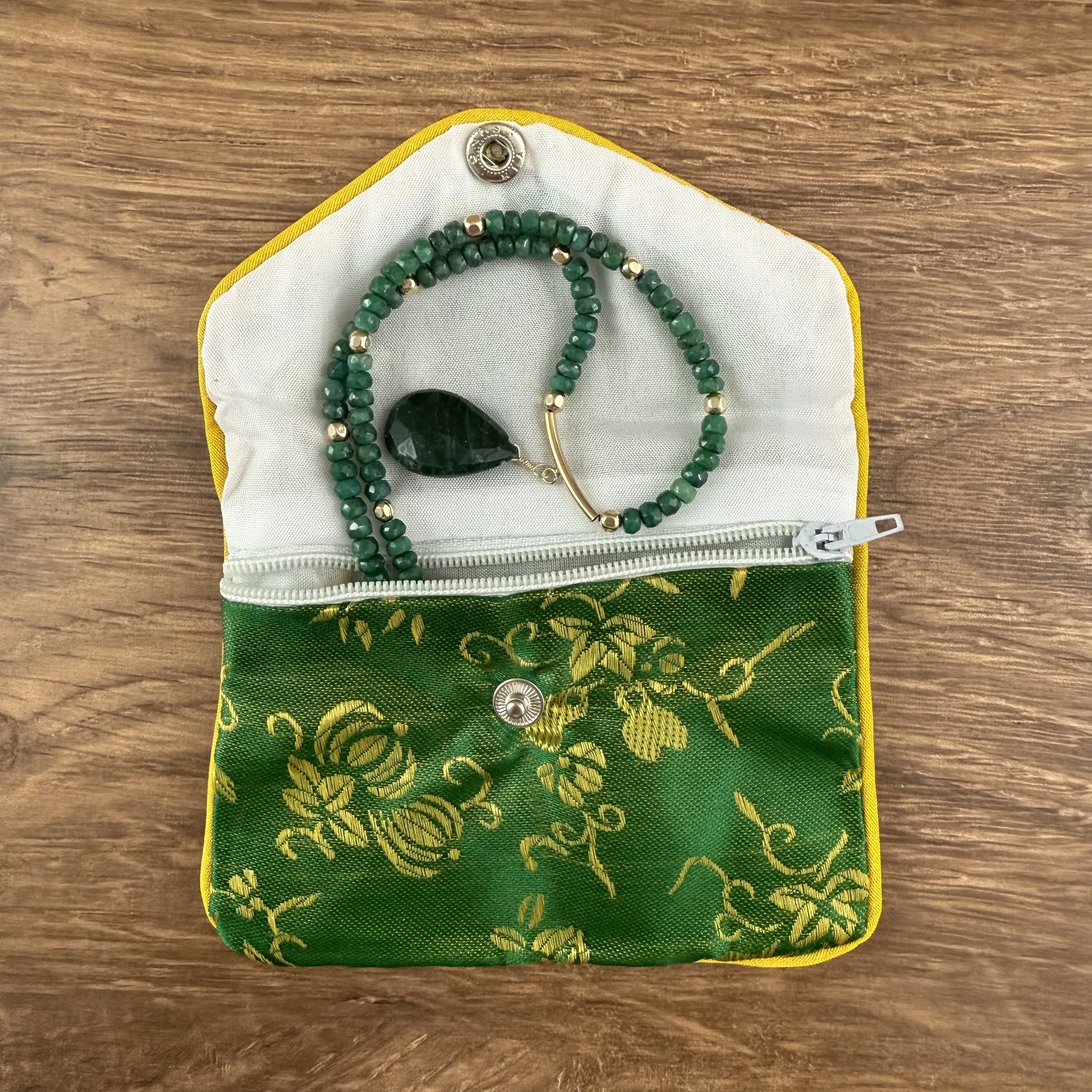 Emerald necklace in jewelry pouch