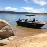 Boat on shore with brolly