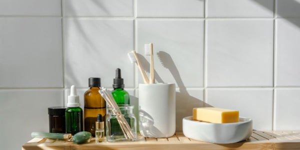 bathroom shelf with toothbrush in holder, soap in a soap dish, various personal care items found in the bathroom