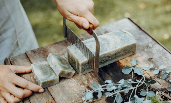 soap on a cutting board, being handcut.