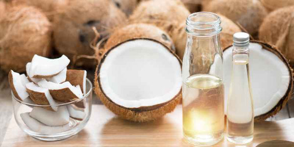 the smelly panda soap company coconuts on a table with a jar of coconut oil and a bowl of coconut shell