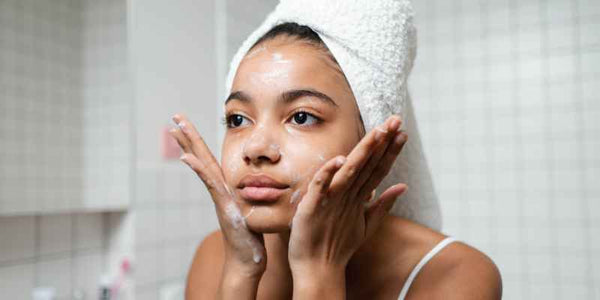 the smelly panda soap company girl washing her face with her hair wrapped in a towel