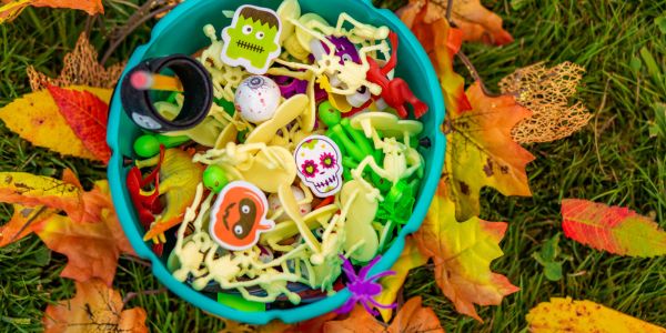 the smelly panda soap company a bowl of halloween party favors sitting outside in a small pile of autumn leaves