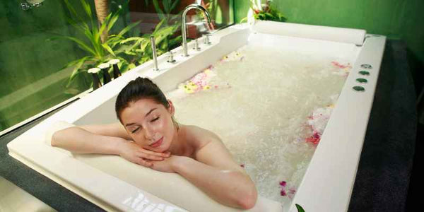 the smelly panda soap company lady soaking in bathtub with botanicals and bubbles